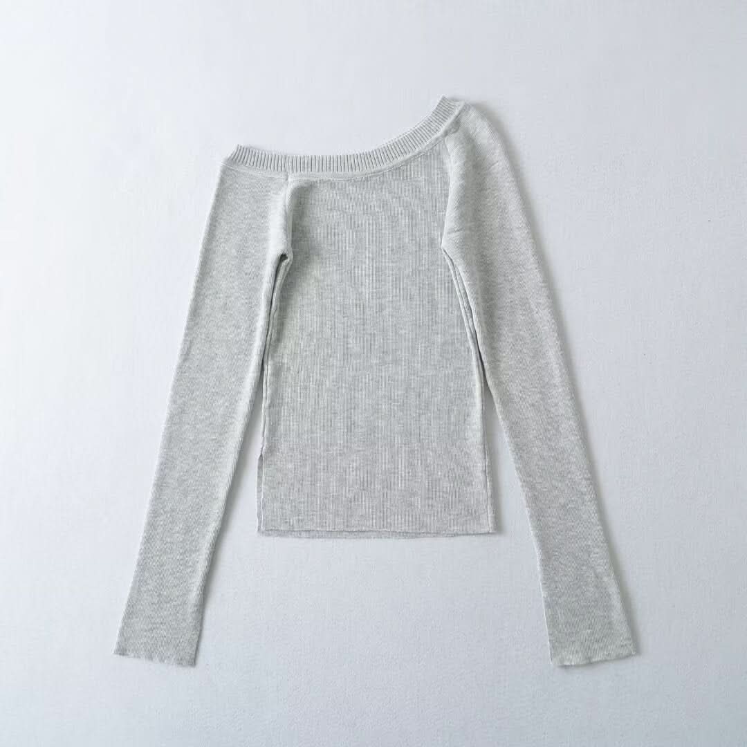 Slanted shoulder, exposed shoulder, open cuffs, top